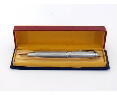 A white metal fountain pen, with banded engine turned decoration to barrel and cap, piston filler and fine iridium nib (inked