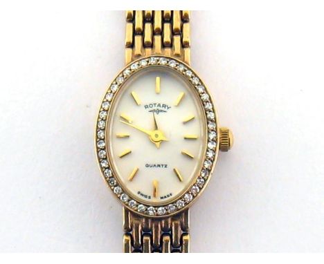 Rotary, a lady's 9 carat gold and diamond quartz wristwatch, the small white oval dial with baton markers and sword hands, wi