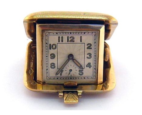 A 1930s 9 carat gold purse watch, the cushion shaped folding case with square engine turned dial, luminous Arabic numerals an