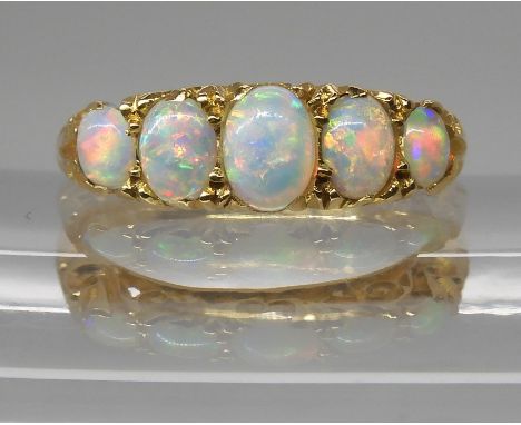 AN 18CT GOLD FIVE STONE OPAL RING the opals are very lively with the full spectrum of colours, well matched to each other. In