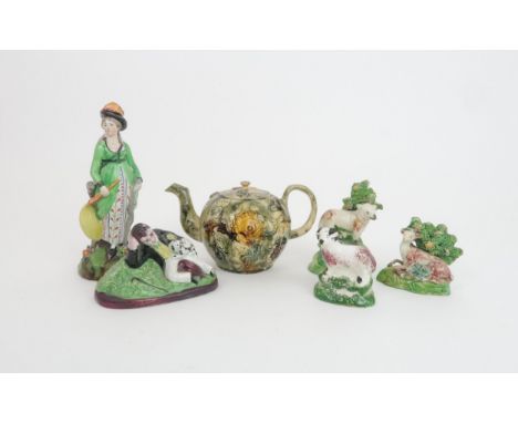 A WHIELDON-TYPE TEAPOT with applied floral decoration and slip glaze, a Pearlware figure of a lady with a bow and arrow, a pe