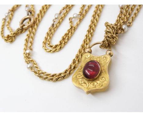 A YELLOW METAL &amp; PEARL GUARD CHAIN WITH GARNET CLASP the bright yellow metal rope chain, is interspaced with pearls. The 