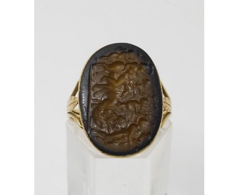 AN OF THE ANTIQUE GLASS INTAGLIO depicting a Bacchanalian scene, dimensions 21.5mm x 15.6mm, in a Georgian style ring mount. 