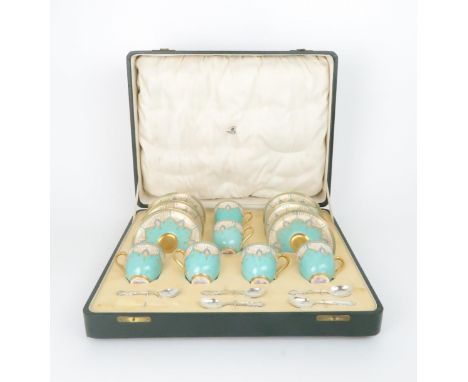 A 1930's BOXED ROYAL WORCESTER COFFEE SET the demitasse cups and saucers with turquoise and gilt decoration, with six silver 