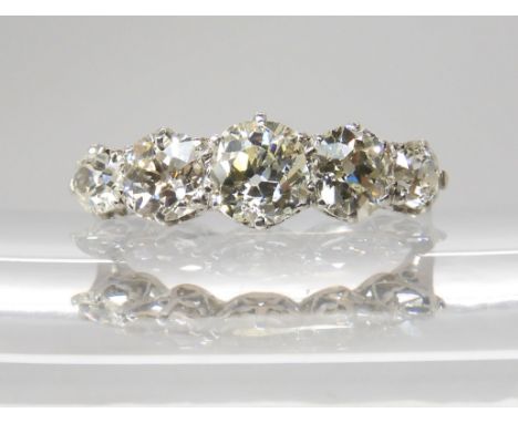 A FIVE STONE DIAMOND RING mounted in white metal with a finely made gallery, the five diamonds combined have an estimated app