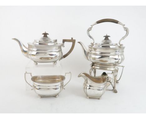 A GEORGE V FOUR PIECE SILVER TEA SERVICE comprising a spirit kettle and stand, teapot, sugar bowl and cream jug, the bodies l