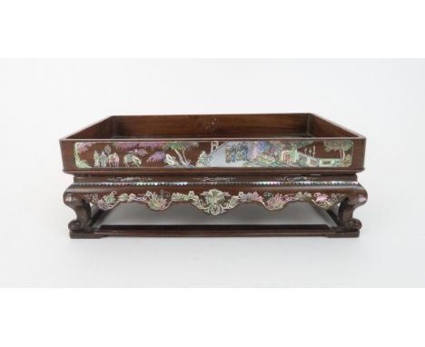 A CHINESE HARDWOOD AND ABALONE STAND decorated with fruit and foliage, the rectangular tray above a shaped apron and on scrol