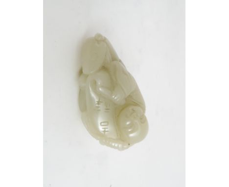 A CHINESE JADE FIGURE CARVING the recumbent figure holding a scroll, with a toad, 6cm wide and 3cm high Condition Report:Avai