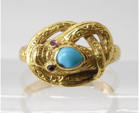 A SNAKE RING WITH RUBY EYES&nbsp; engraved throughout with a scroll pattern, the top of the head set with a turquoise. finger