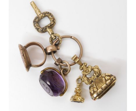 A COLLECTION OF SEALS a yellow metal mounted amethyst triple faced seal, engraved with a large dog and the motto Fide Et Vert