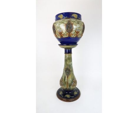 A DOULTON LAMBETH JARDINIERE AND STAND the green ground with Art Nouveau style floral and foliate decoration, 86cm high, the 