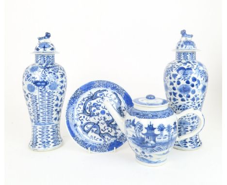 A PAIR OF CHINESE BLUE AND WHITE VASES AND COVERS painted with fruit and foliage, with shishi finials, 33cm high,a Chinese ex