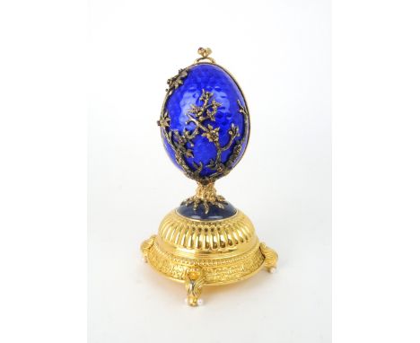 A HOUSE OF IGOR CARL FABERGE MUSICAL SILVER GILT FIREBIRD EGG set with red gems and elements of lapis lazuli and produce by F