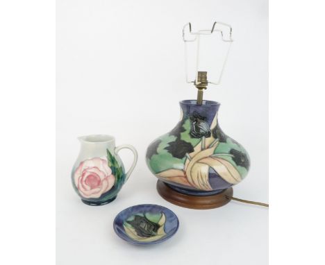 A MOORCROFT BLACK TULIP PATTERN TABLE LAMP designed by Sally Tuffin, 29cm high, a matching coaster/trinket dish, together wit