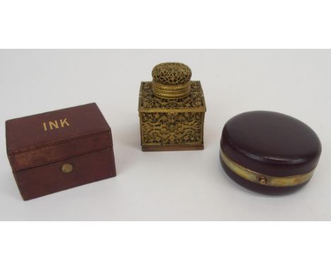 A FRENCH FILIGREE GILT-METAL TRAVEL INKWELL with collapsible sides opening to reveal, candle holder, stamp case, 5cm wide, 7c