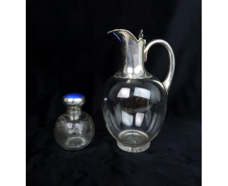 A SILVER TOPPED GLASS CLARET JUG of ovoid form, the silver spout and neck with pie crust edges and clover shaped thumb pieces