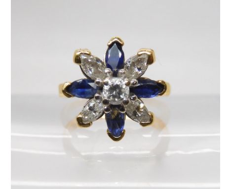 A SAPPHIRE AND DIAMOND FLOWER RING set with four marquis diamonds and a brilliant cut, with an estimated approx diamond combi