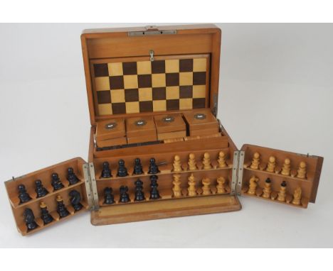 A VICTORIAN GAMES COMPENDIUM with hinged lid and twin flap doors, with associated chess pieces, draughts etc, with cribbage b