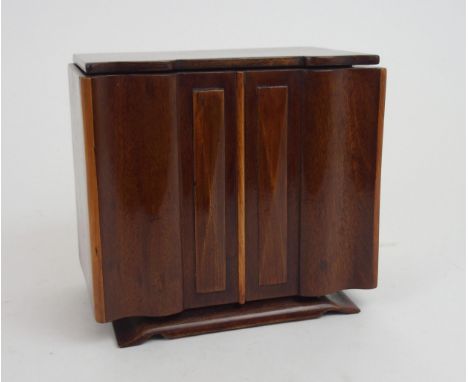 AN ART DECO SPECIMAN WOOD SERPENTINE TEA CADDY modeled as a sideboard with shaped inlaid hinged lid and shaped apron, 1`9cm w