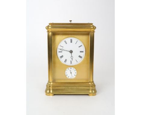 A FRENCH BRASS CARRIAGE REPEATER/ALARM CLOCK with gilt metal and white enamel dial with Roman numerals, 13.5cm high Condition