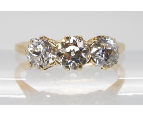 A THREE STONE DIAMOND RING set with estimated approx, 1.78cts of old cut diamonds in classic crown mounts. Finger size N1/2, 