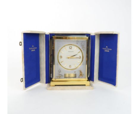 A JAEGER LE COULTRE MARINA MODEL ATMOS CLOCK the white dial within a flexi-glass and brass bound case with gilt chinoiserie d
