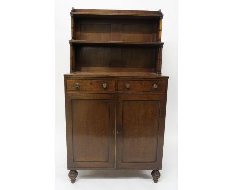 A19TH CENTURY MAHOGANY CABINET with two open book shelves above two drawers above two panel doors on turned feet, 135cm high 