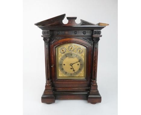 A VICTORIAN CARVED OAK CASED CHIMING BRACKET CLOCK the arched brass dial with slow/fast, chime/silent and chime on 8 bells/We