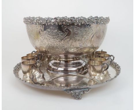 AN IMPRESSIVE SILVER PLATED PUNCH  SET comprising a footed bowl, twelve cups, a lobed ladle and stand, with chased scrolling 