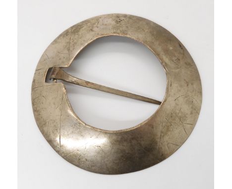 A LARGE WHITE METAL PLAID BROOCH engraved with patterns to the front and the initials A Mc ? to the inside, hand raised plani