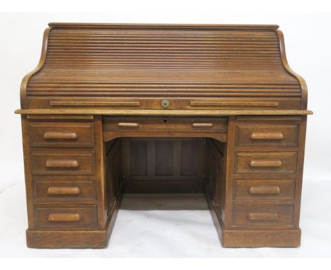 AN EARLY 20TH CENTURY OAK MAPLE & CO LONDON & PARIS TAMBOUR FRONT TWIN PEDESTAL DESK with tambour front concealing fitted int
