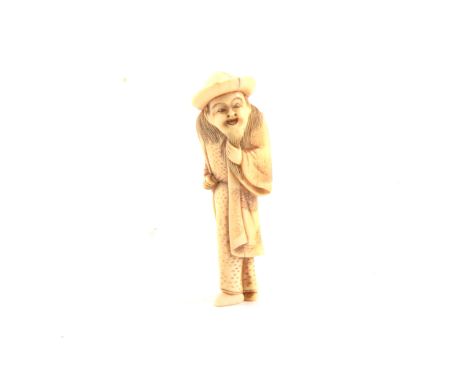 Carved ivory netsuke, bearded elder wearing a hat, 7.2cm long.