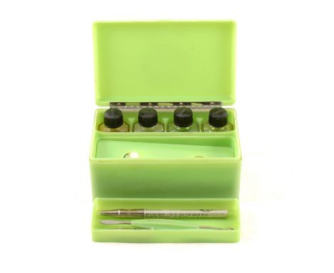 A vintage bakelite 'Manicase' manicure set, by Manex, in pale green, the cover with Art Deco style roundel of a female face a