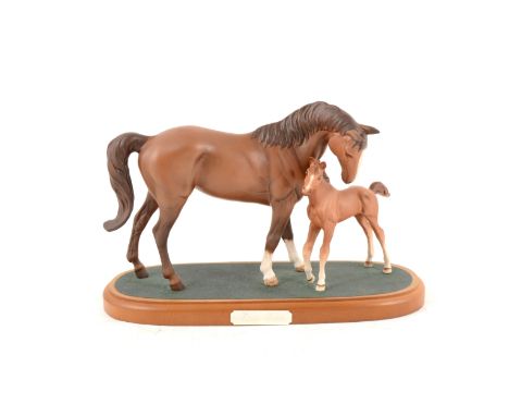 Royal Doulton horse figure group "First Born", brown matt model of a mare and foal on a wooden plinth, 18.5cm high, 28.5 wide