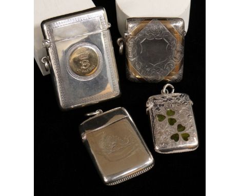 FOUR SILVER VESTA CASES comprising two similar silver and enamel three leaf clover examples, silver and 9ct gold mounted vest