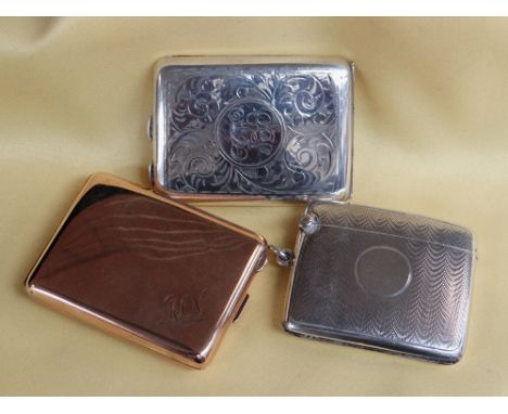 THREE VESTA / MATCH CASE HOLDERS comprising engine turned silver vesta case of curved form, silver lined 9ct gold plated matc