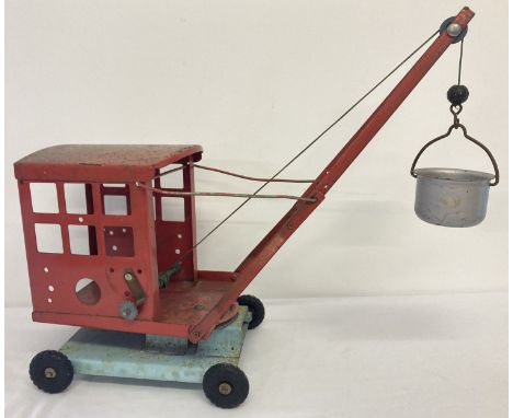 A vintage red and blue 1950's No. 2 tinplate crane with bucket and swivel base by Tri-Ang.   Total height approx. 40cm.