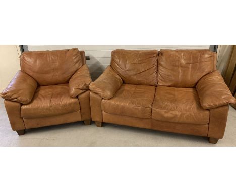 A modern design 2 seater tan leather sofa and matching armchair with square wooden feet.  Fire labels to underside.  Sofa app