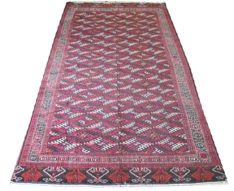 ANTIQUE YOMUT CARPET, 370cm x 206cm, repeat polychrome tribal guls inside multiple geometric bands and borders.