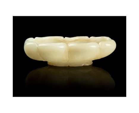 WHITE JADE FOLIATED BRUSH WASHER QING DYNASTY, 18TH-19TH CENTURY 清 白玉雕荷葉形筆洗 in the form of a folded lotus leaf, supported on 