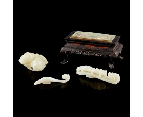 GROUP OF FOUR JADE CARVINGS 白玉及青白玉龍紋帶鈎、青玉蓮藕擺件 及 木座嵌青玉透雕龍紋牌（一組四件） comprising: two belt hooks, the smaller one carved from a wh