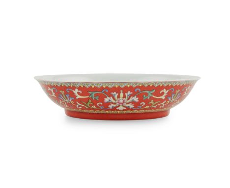 RUBY-RED-GROUND FAMILLE ROSE 'LOTUS AND BAT' PLATE QIANLONG MARK BUT 19TH CENTURY 清 乾隆款 珊瑚紅地粉彩番蓮紋五福捧壽盤 supported on a short s