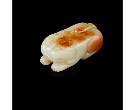 CELADON JADE WITH RUSSET SKIN 'TIGER' PENDANT QING DYNASTY, 18TH-19TH CENTURY 清 青玉帶皮雕臥虎 carved in round from a pebble, depict