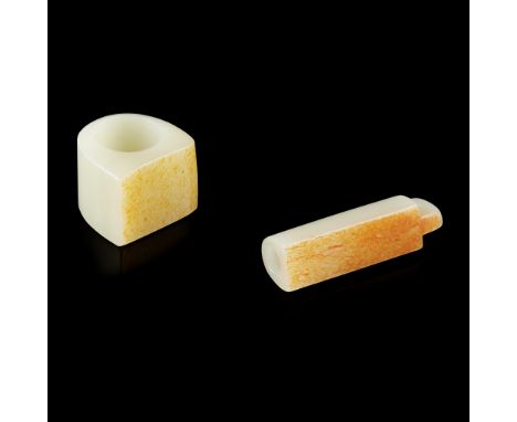 TWO CELADON JADE CARVINGS 青玉巧雕扳指 及 翎管（兩件） comprising: a thumb ring; and a feather holder in tubular form with one side flatte
