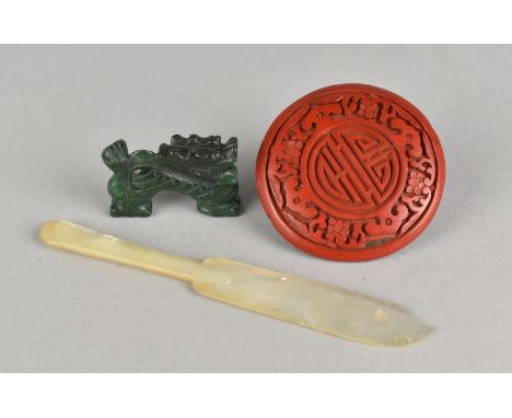 A Carved Jade Dog of Foo, Cinnabar Disc and Mother of Pearl Caviar Knife