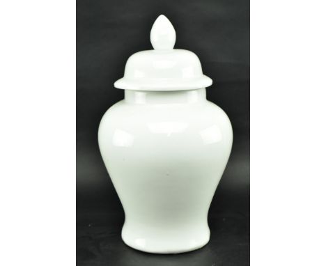 A large 20th century white ceramic ginger jar with lid. The jar with drop shaped finial lid, flared rim &amp; bulbous body. M
