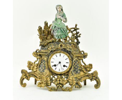 A 19th century French gilt metal and bronze mantle clock. The clock with a cold painted bronze finial figure of a farming mai