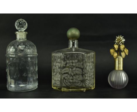 A collection of three vintage 20th century glass perfume bottles. The lot including an empty factice glass perfume bottle mar
