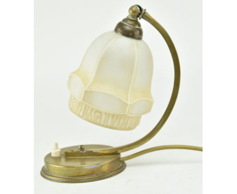 A 1930s brass and milk frost glass table / desk lamp. The terraced brass base with push button inset. Brass arched arm suppor