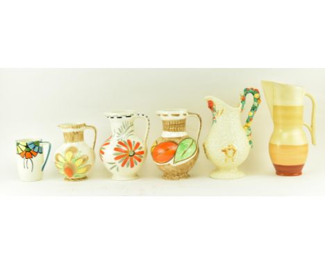 A collection of six early 20th century circa 1930s &amp; later ceramic jugs / pitchers. The lot comprising a Clarice Cliff Ce